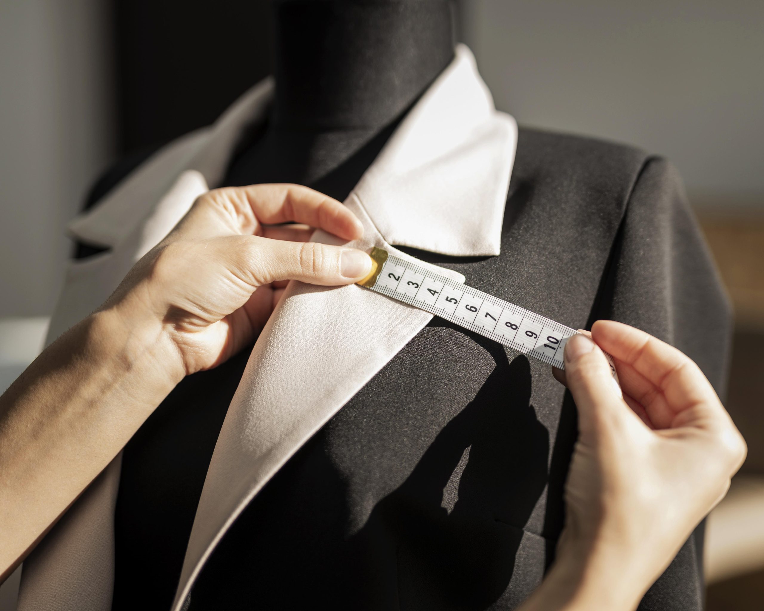 woman-making-jacket-close-up-scaled